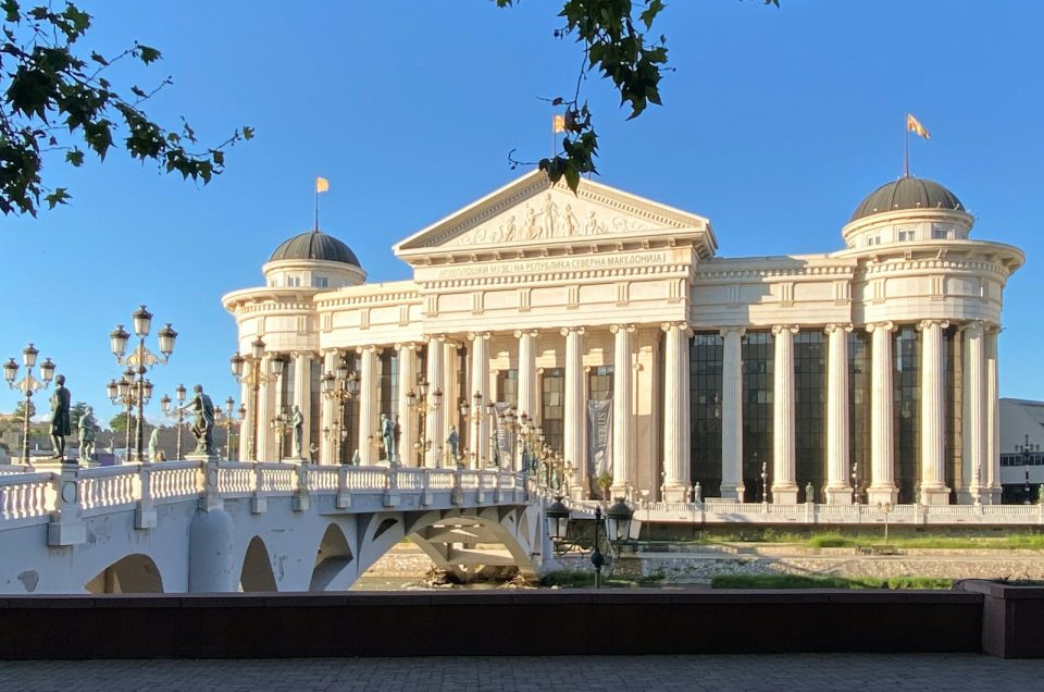 a white building with a white bridge in front of it